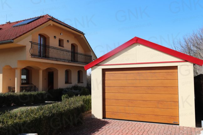 Eine Einzelgarage mit rotem Satteldach bei einem Familienhaus