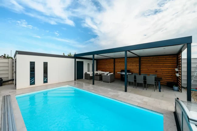 Nahaufnahme des Gartenhauses, des Pools und der Pergola mit Esstisch