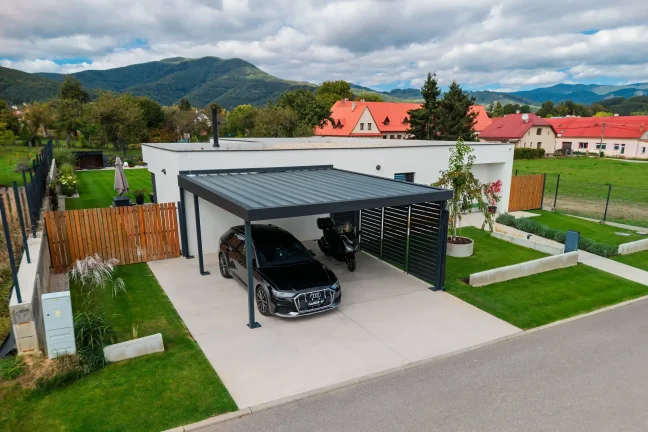Drohnenaufnahme des Carports für zwei Autos mit Auto und Motorrad am Einfamilienhaus